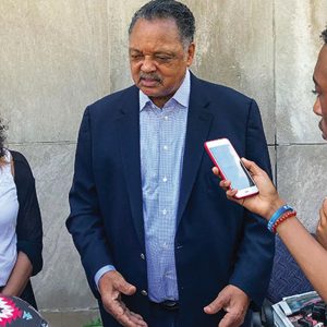 CRUSADER SUMMER INTERN Elae Hill (far right) records an unexpected interview with Reverend Jesse Jackson at the Chicago Defender’s offices on July 10. Jackson visited the newspaper as it published its last edition. The publication will now be digital only.